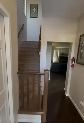 a hallway with a stairway with a stair case at Peace Home in Calgary
