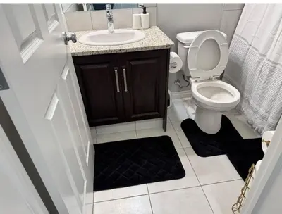 a bathroom with a toilet and a sink at Quiet Comfortable 1-Bedroom in Calgary