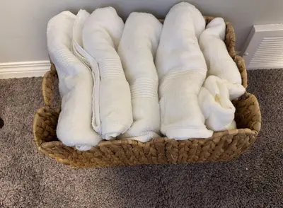 a basket filled with white socks on the floor at Quiet Comfortable 1-Bedroom in Calgary