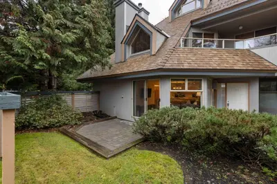a large house with a porch and a yard at Glen Eagles by Whistler Premier in Whistler