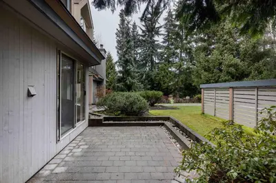 a walkway next to a house next to a yard at Glen Eagles by Whistler Premier in Whistler