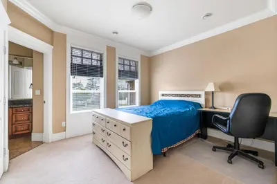 a bedroom with a bed and a desk and a chair at Cozy Private Space in Richmond with Modern Comforts in Richmond