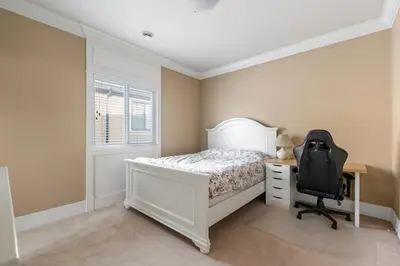 a bedroom with a white bed and a desk and a chair at Cozy Private Space in Richmond with Modern Comforts in Richmond
