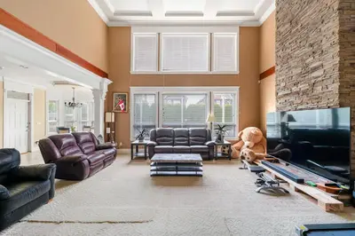 a living room with leather furniture and a large fireplace at Cozy Private Space in Richmond with Modern Comforts in Richmond