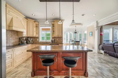 a kitchen with a large island with two bar stools at Cozy Private Space in Richmond with Modern Comforts in Richmond
