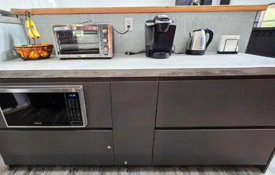 a kitchen counter with a microwave on a counter top at Copper Rose Retreat - Mountain B&B in Invermere