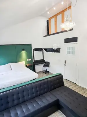a bedroom with a bed and a chair in it at Copper Rose Retreat - Mountain B&B in Invermere