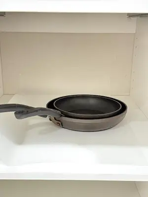 a black frying pan sitting inside of a drawer at Private 2BR Lake Suite - Chestermere - Sleeps 6 in Chestermere