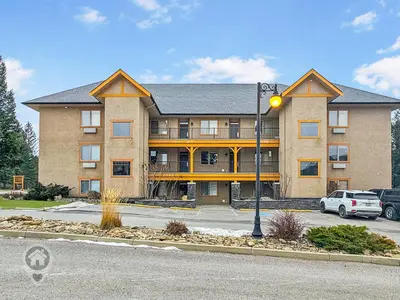 a large building with a street light in front of it at Bighorn Meadows Condos by StayIn in Radium Hot Springs