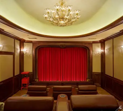 a theatre with a red curtain and a chandelier at Chateau Okanagan in Kelowna
