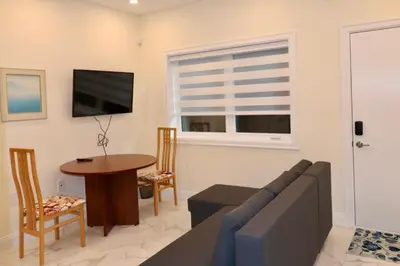 a living room with a couch and a table at SixPine - One bedroom suite in Vancouver
