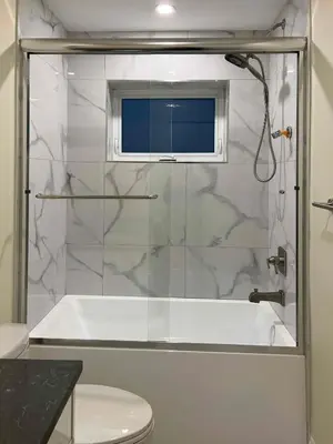 a bathroom with a shower with a tub and a toilet at SixPine - One bedroom suite in Vancouver