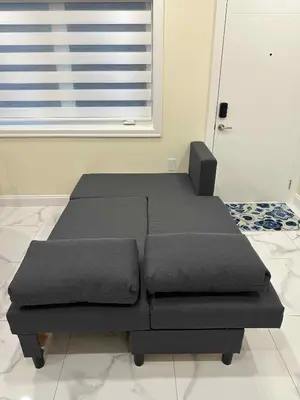 two beds in a room with a window at SixPine - One bedroom suite in Vancouver