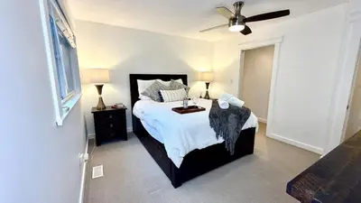 a bedroom with a bed and a ceiling fan at Emerald 3Bed 1bath Rancher 2C-D EvEs Spa BBQ RKE in Langley