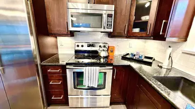 a kitchen with a stove and a microwave at Emerald 3Bed 1bath Rancher 2C-D EvEs Spa BBQ RKE in Langley