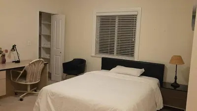 a bedroom with a bed and a desk and a chair at Vancouver Richmond Villa47 in Vancouver