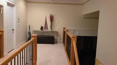 a living room with a staircase and a fireplace at Vancouver Richmond Villa47 in Vancouver