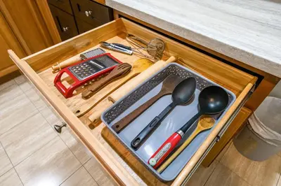 a wooden drawer with utensils on a counter at Comfortable Westside Vancouver Stay in Vancouver