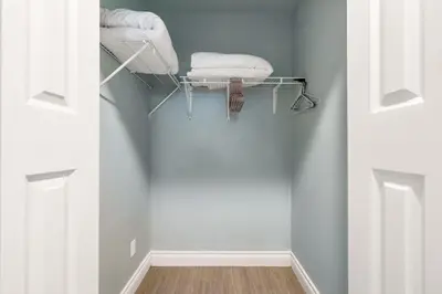 a hallway with white towels on a shelf in a room at Comfortable Westside Vancouver Stay in Vancouver