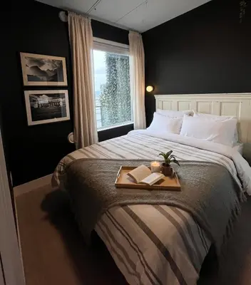 a bedroom with a bed with a tray with two books at Modern & Stylish Condo in Langley City in Langley