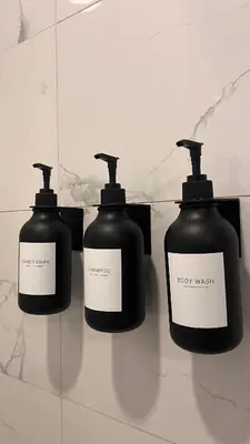 a group of three bottles of soap on a wall at Modern & Stylish Condo in Langley City in Langley