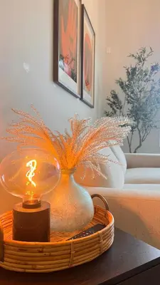 a table with a vase with a candle on it at Modern & Stylish Condo in Langley City in Langley