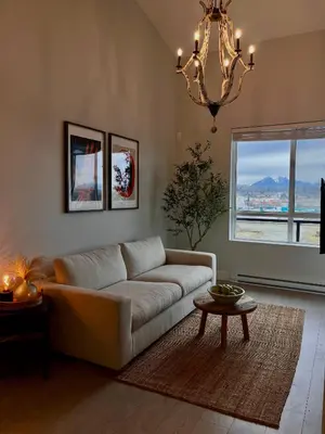 a living room with a couch and a chandelier at Modern & Stylish Condo in Langley City in Langley