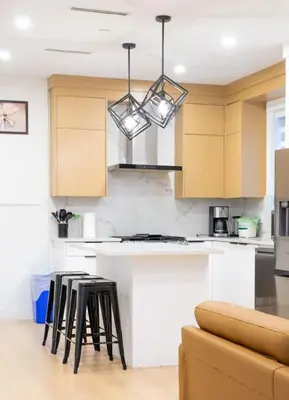 a kitchen with a counter and stools in a room at Elegant Stylish Modern Residence in Vancouver