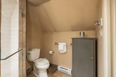 a small bathroom with a toilet and a shower at Foxglove 22 by Outpost Whistler in Whistler