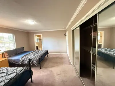 a bedroom with two beds and a sliding glass door at Cozy Private Queen room Scott Rd in Bélanger