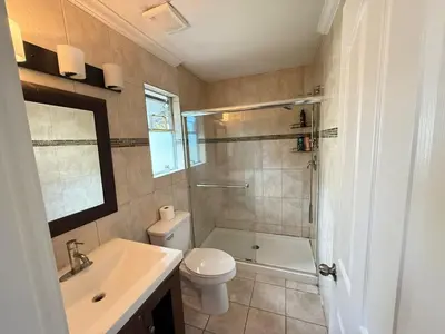 a bathroom with a toilet and a sink and a shower at Cozy Private Queen room Scott Rd in Bélanger