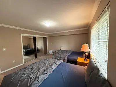 a bedroom with two beds and a window at Cozy Private Queen room Scott Rd in Bélanger