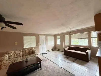 a living room with a couch and a table at Cozy Private Queen room Scott Rd in Bélanger