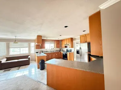 a kitchen with wooden cabinets and a counter top at Cozy Private Queen room Scott Rd in Bélanger