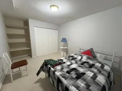 a bedroom with a bed and a chair in it at Private Room near Scottsdale Shopping Centre in Bélanger