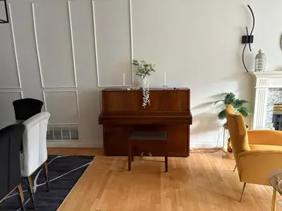 a piano in a living room with a couch and chairs at Private Room near Scottsdale Shopping Centre in Bélanger