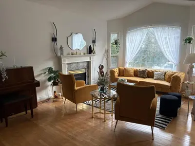 a living room with a couch and chairs and a piano at Private Room near Scottsdale Shopping Centre in Bélanger