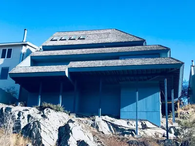 a building sitting on top of a mountain at See Aurora and lake from EVERY room - 2bd 2bth in Yellowknife