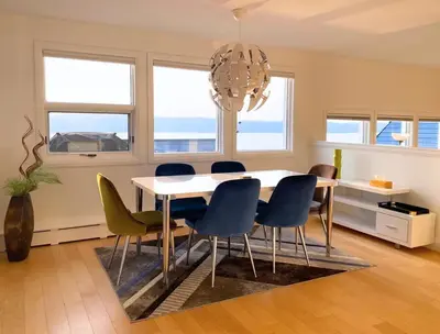 a dining room with a table and chairs at See Aurora and lake from EVERY room - 2bd 2bth in Yellowknife