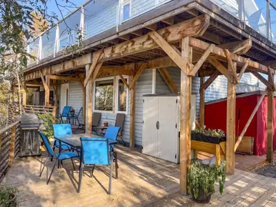 a wooden patio with a table and chairs on a deck at Cozy 1 br apartment in Old Town by lake in Yellowknife