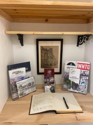 a desk with a pen and some books on it at Cozy 1 br apartment in Old Town by lake in Yellowknife