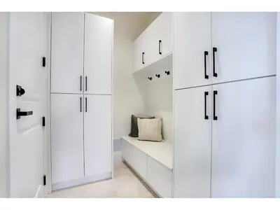 a white closet with white cabinets and a pillow at BRAND NEW LUXURY 4 Beds 4 baths Home Langley Perfect for Families and Groups in Langley