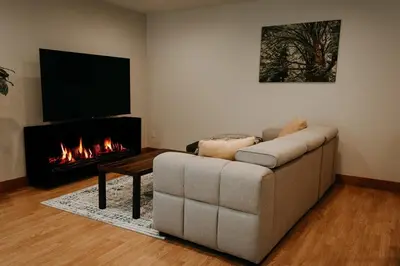 a living room with a couch and a fireplace at Quadra Island Mist in Quathiaski Cove
