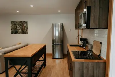 a kitchen with a counter top and a refrigerator at Quadra Island Mist in Quathiaski Cove
