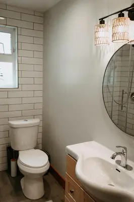 a bathroom with a toilet and a sink and a mirror at Quadra Island Mist in Quathiaski Cove