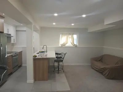 a kitchen with a table and a chair in it at Aeropuerto basement in Calgary