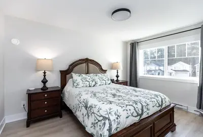 a bedroom with a bed and a window at Cozy Corner on Trumpeter in Colwood