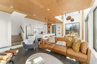 a living room with a couch and a table at Hot Tub & Amazing Ocean View -The Simple Peak - Non pet friendly in Port Renfrew