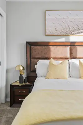 a bedroom with a large bed with a wooden headboard at Family 3BR Suite w Kid's Play Tent, FREE Banff Pass, Netflix! in Calgary