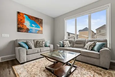a living room with a couch and a table at Family 3BR Suite w Kid's Play Tent, FREE Banff Pass, Netflix! in Calgary